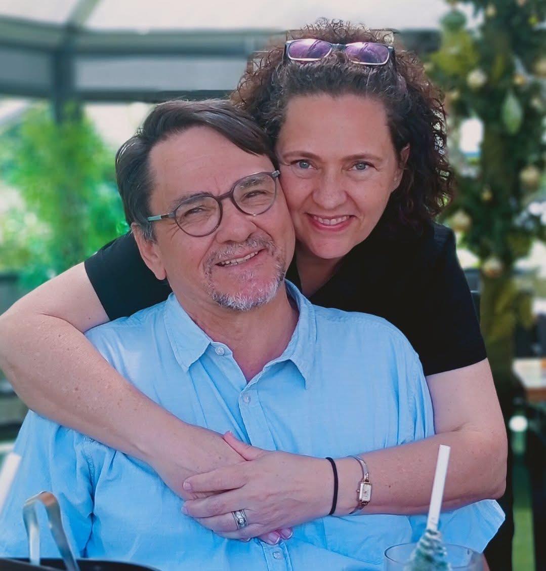 A veteran and his wife embracing warmly